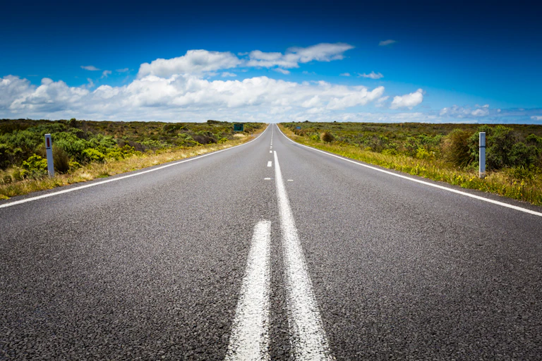 View to the horizon from the middle of a long road in Victoria, Australia