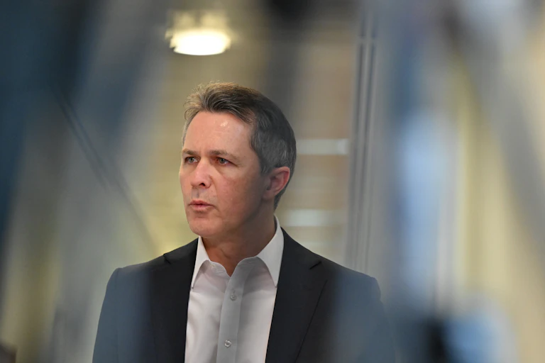 Education Minsiter Jason Clare speaks in a corridor at Parliament House, Canberra.