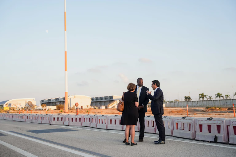 David Lammy talking to two other people on a deserted road in Tel Aviv.