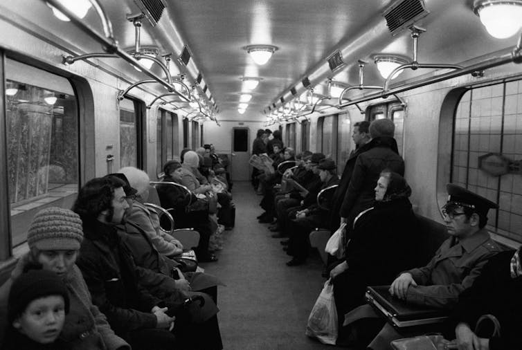 black and white photo of people sitting on subway in Moscow, 1977