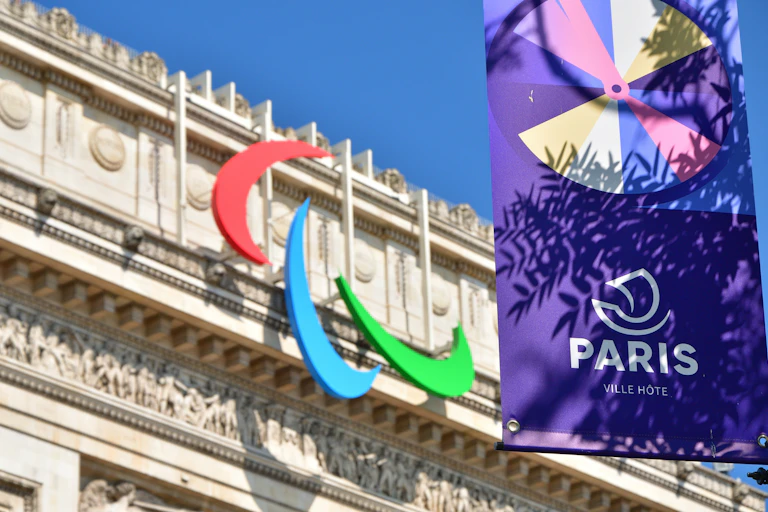 The Paralympic logo seen on the front of an ornate stone building