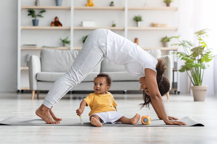 A woman with a baby on an exercise mat