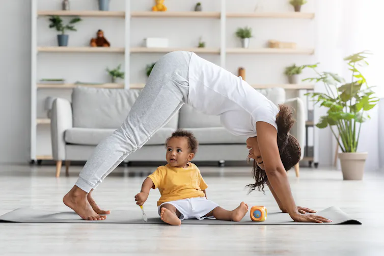 A woman with a baby on an exercise mat