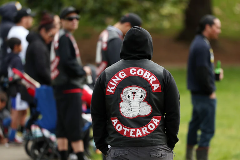 Members of the King Cobra gang watch club rugby league at Grey Lynn Park on August 5, 2017 in Auckland, New Zealand.