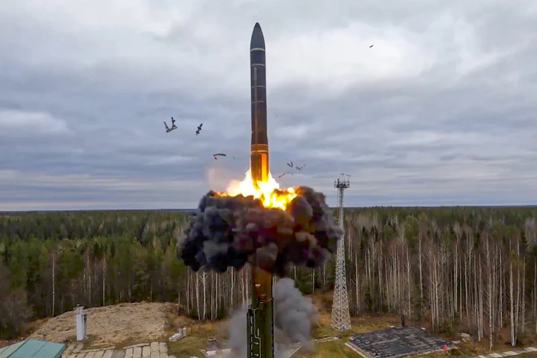 Missile launching from a silo surrounded by trees