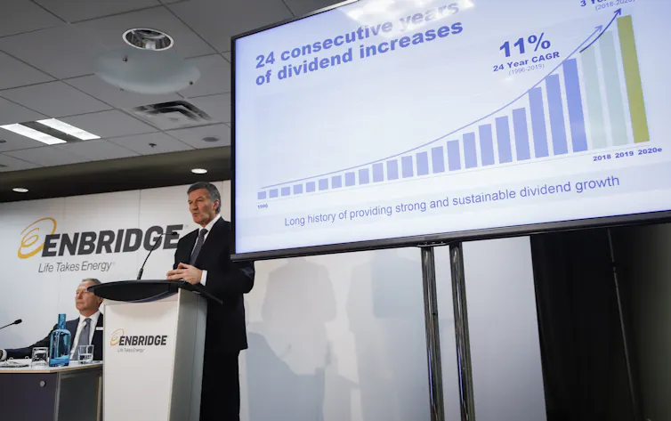 A man seen with a chart showing increasingly larger data pillars.