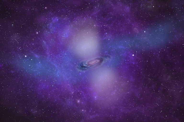 Photo of a tiny swirling galaxy surrounding by a huge cloud of gas