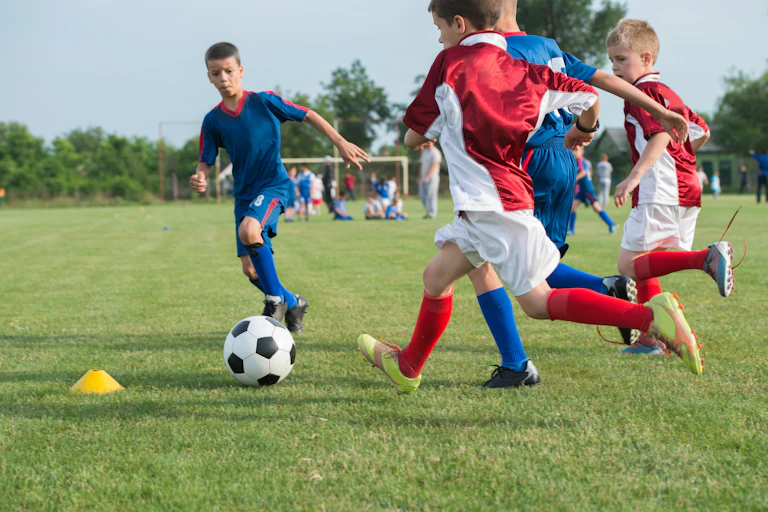 Young children playing soccer