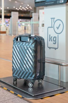 Suitcase on scales at airport