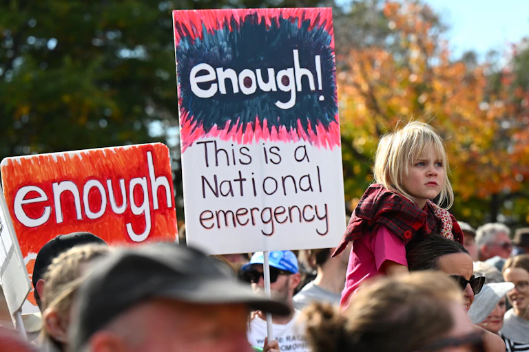 A protest sign that says enough! this is a national emergency