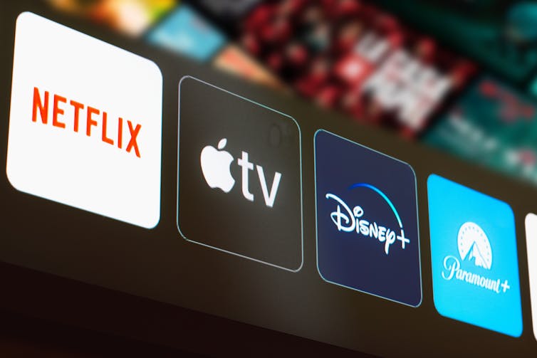 Logos on a TV screen saying Netflix, Apple TV, Disney+ and Paramount+