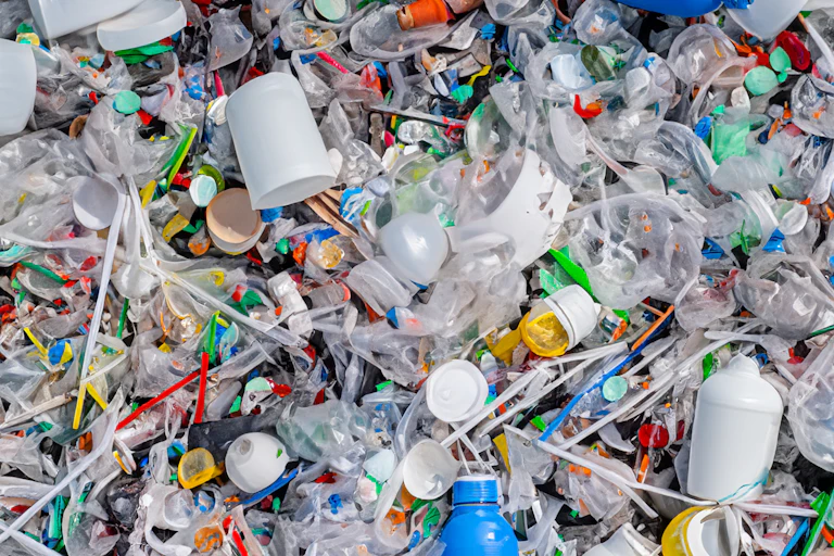 shot of colourful plastic litter, cups, bottles, straws