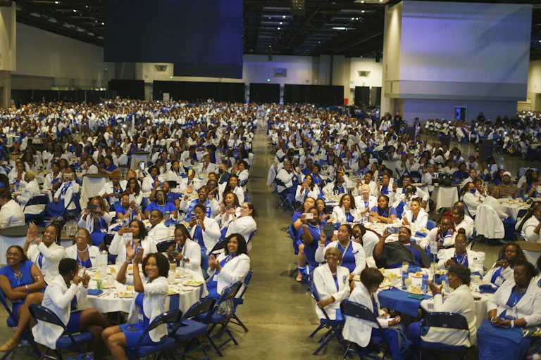 Thousands of Black women sit at dozens of tables to listen to a speech by US Vice President Kamala Harris.