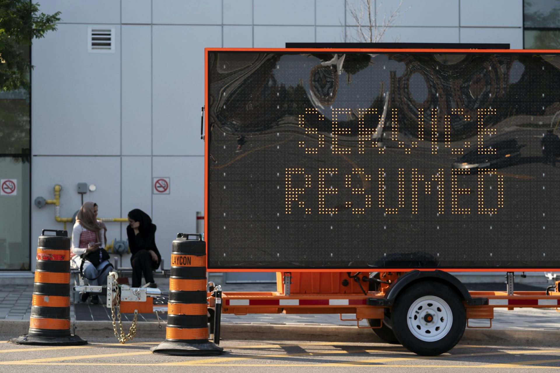 A digital sign that says 'Service Resumed'