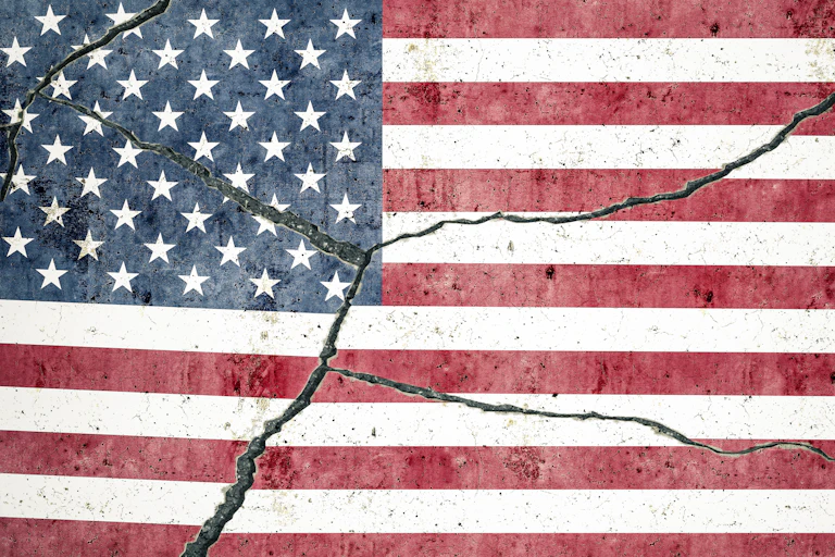 An American flag shows cracks down the center.