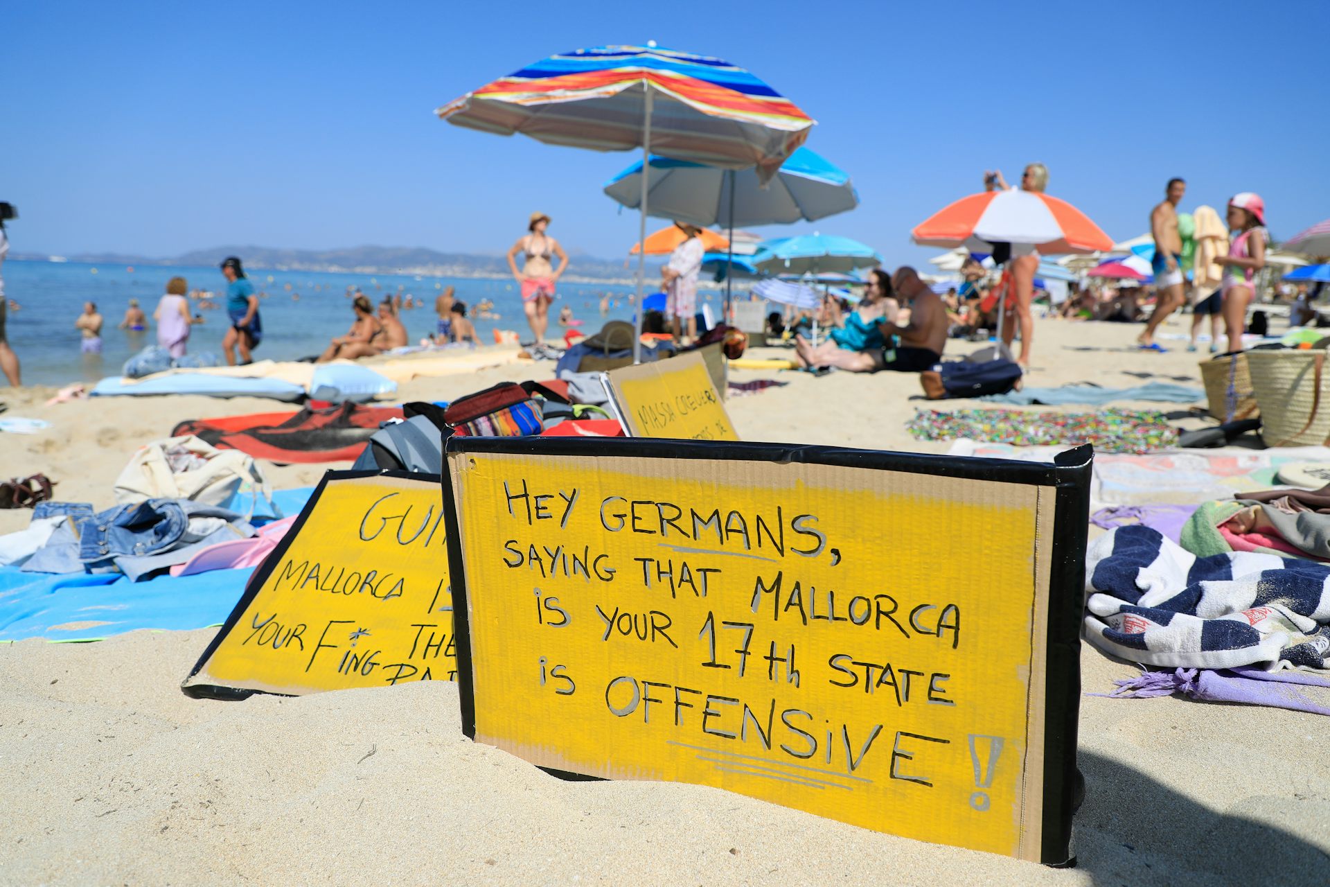 Protest sign on beach in Mallorca saying 