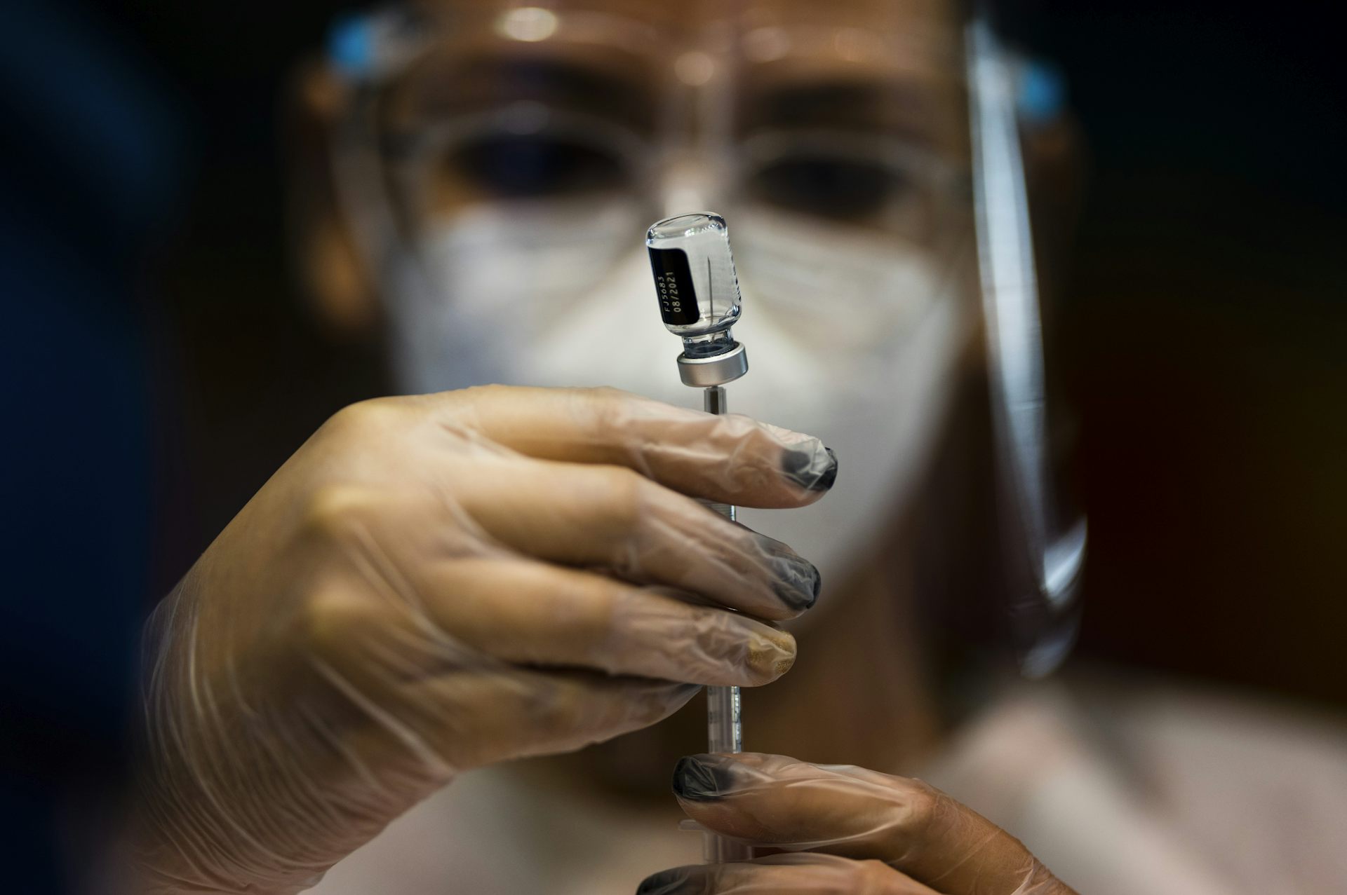 A nurse drawing up a vaccine.