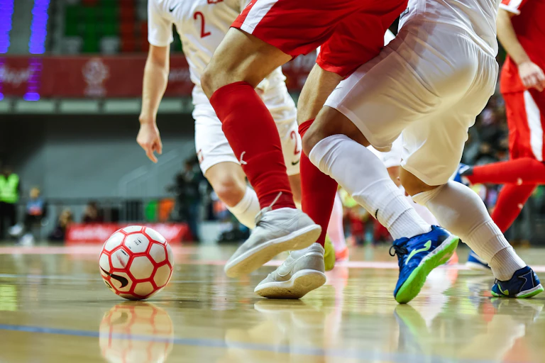 Futsal players compete for the ball