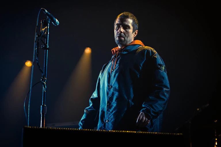 Liam Gallagher wearing Stone Island jacket on stage