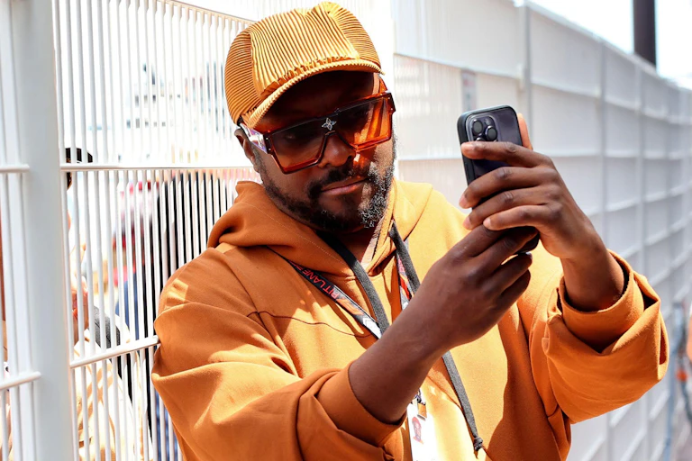 Will.i.am with a smartphone