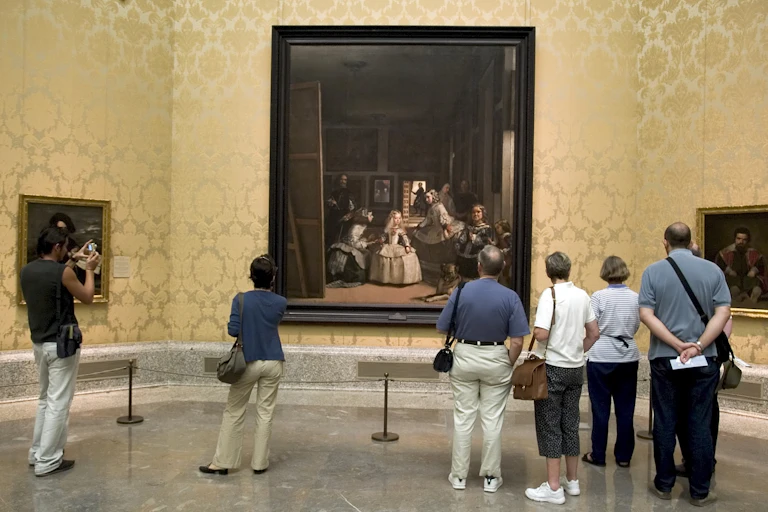 Vistors at the Prado Museum in Madrid look at Velázquez's painting 'Las Meninas'.
