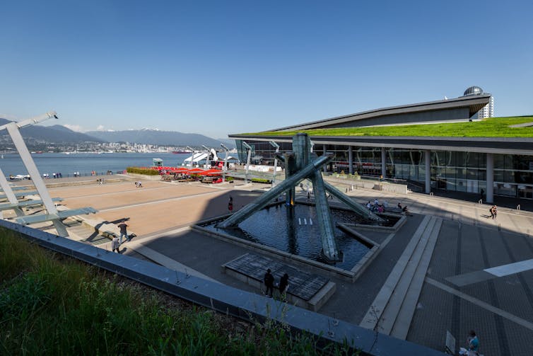a corporate-looking building with grass on its flat roof.