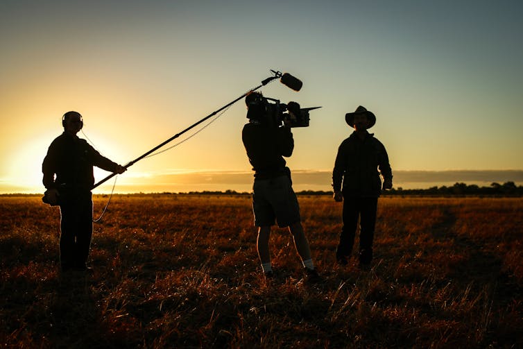 Camera crew shooting film in a paddock in rural Australia