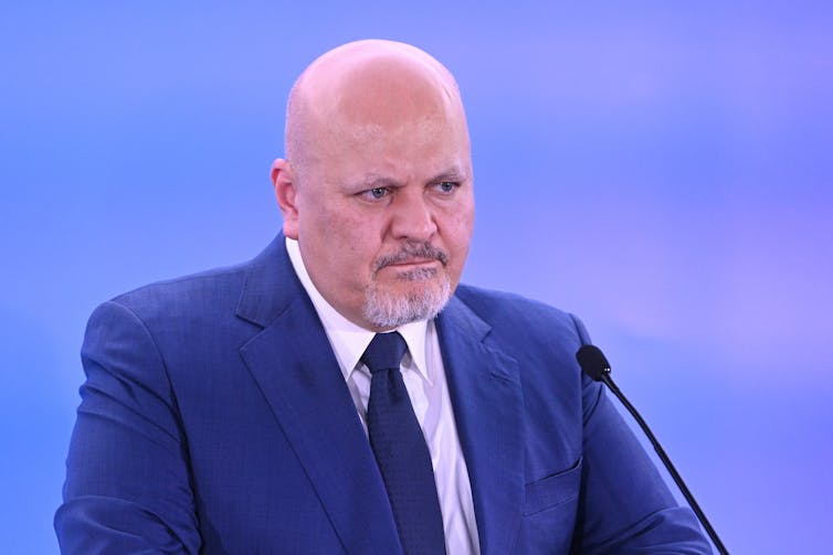 Karim Khan in a navy blue suit.