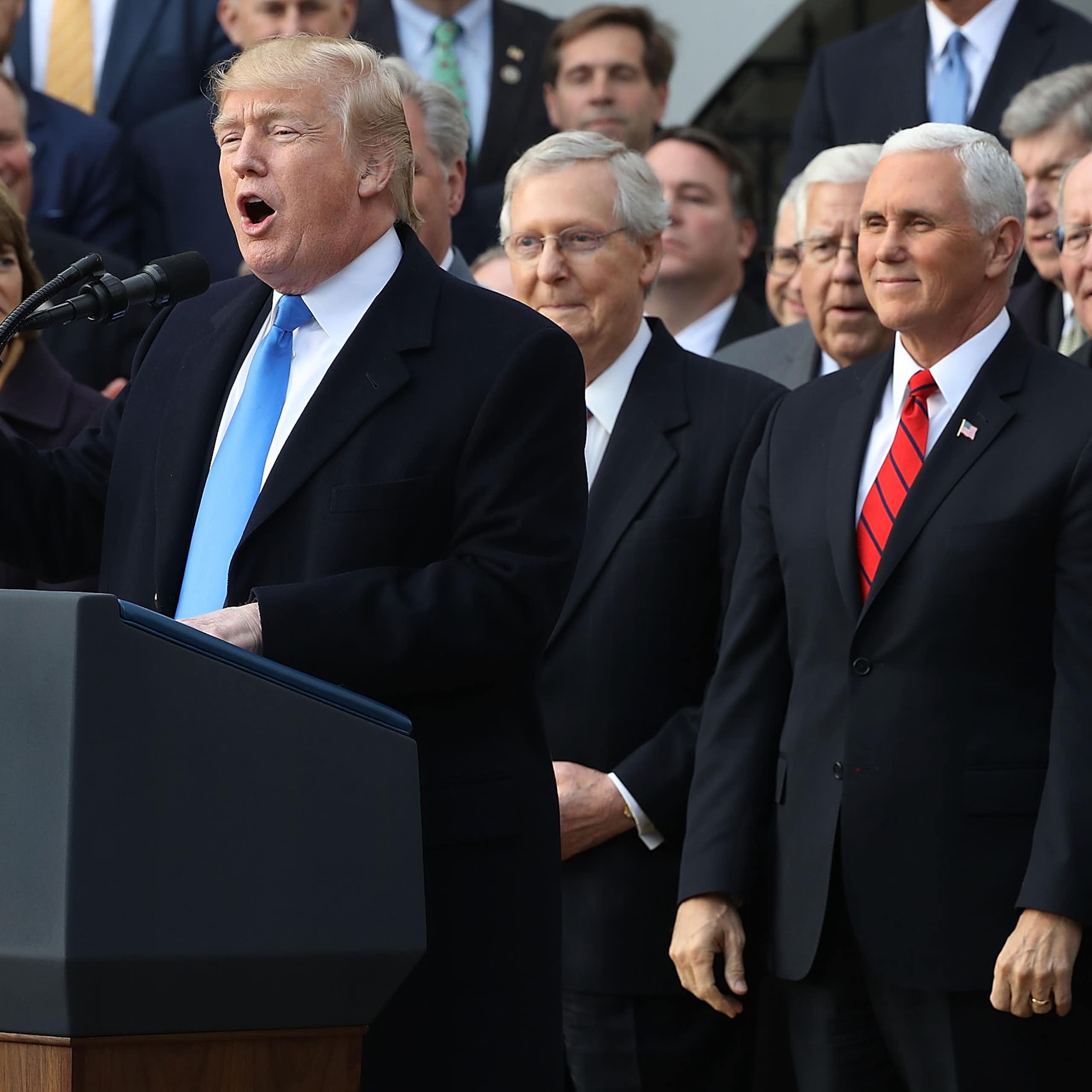 Donald Trump speaks at a lectern flanked by members of Congress early in his presidency.