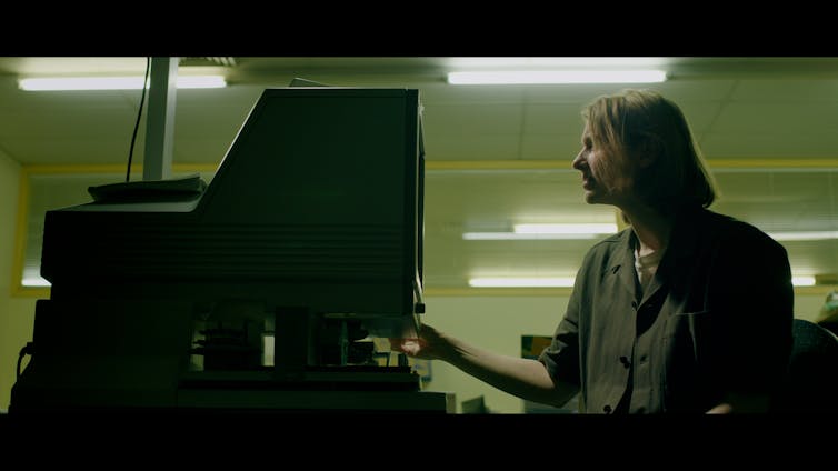 Kathryn Joy at a microfiche reader.