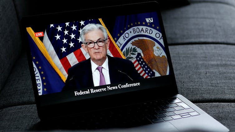 us federal reserve chair jerome powell on a laptop screen
