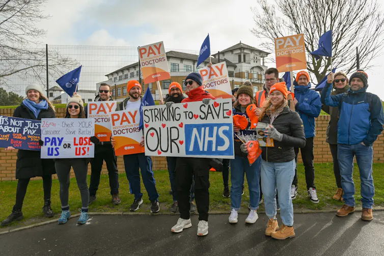 NHS strikers with placards.