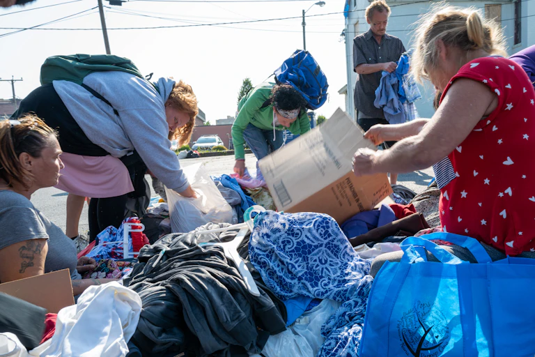 People look through donated clothes.