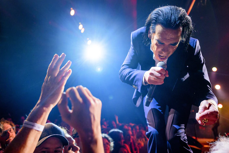 Nick Cave singing to a crowd