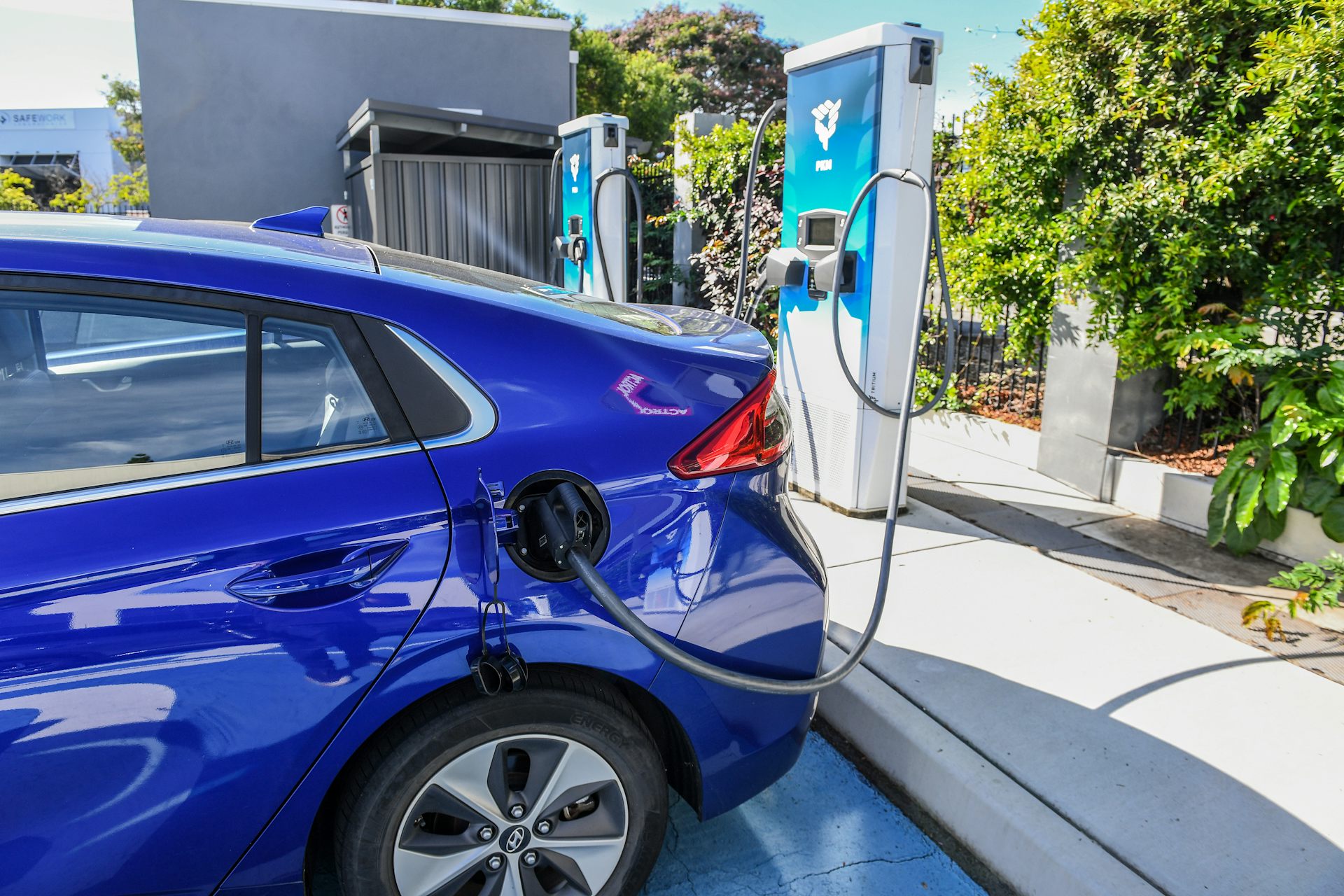 An electric vehicle being charged at a public charging station