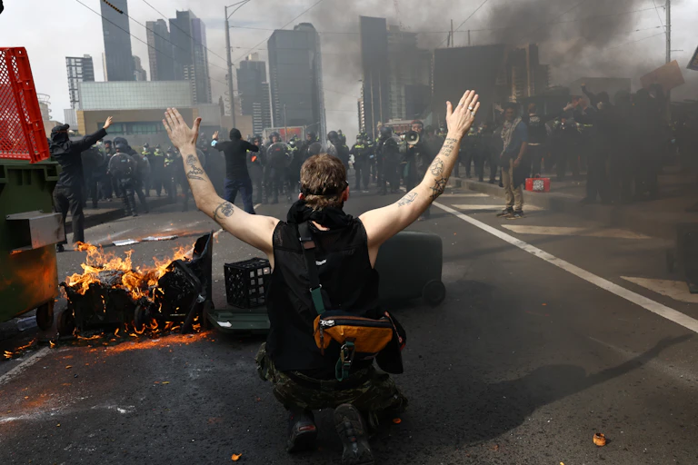 Protesters are seen during a protest against the LandForces International Land Defence Exposition at the Melbourne Convention and Entertainment Centre in Melbourne