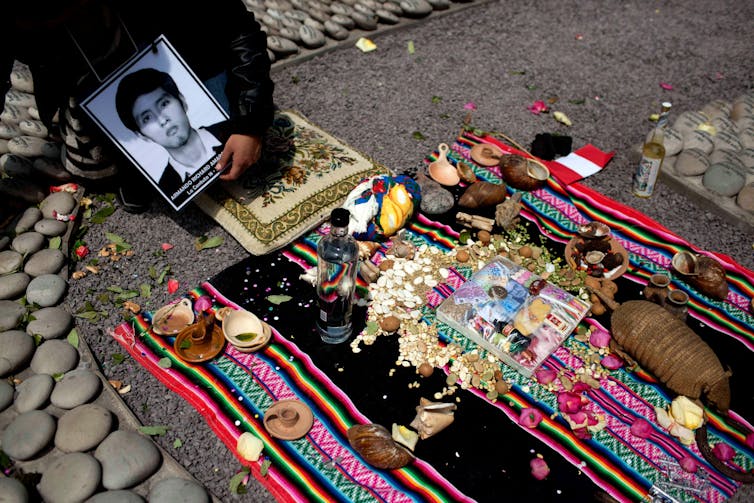A photo of a man is held is a memorial