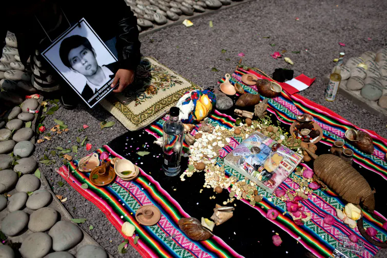 A photo of a man is held is a memorial