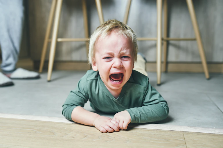 Child having a tantrum on the floor