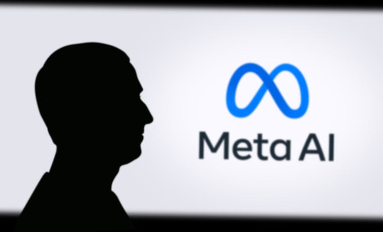 Silhouette of man in front of Meta logo.