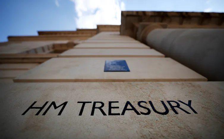 'HM Treasury' black lettering on a sandstone building.