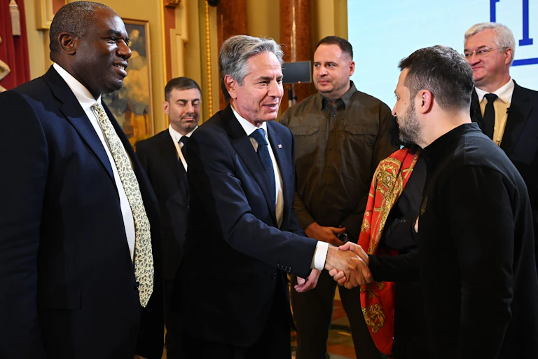 Zelensky shakes hands with US Secretary of State Antony Blinken.