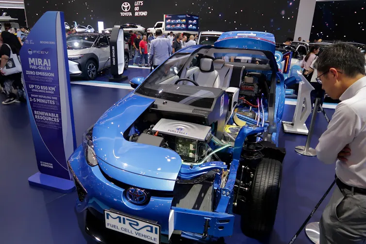 people look at blue high-tech car