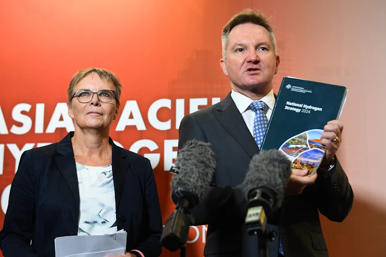man holding brochure with woman to his right