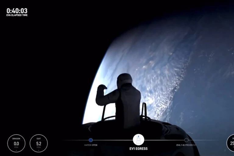 Photo showing the silhouette of an person emerging from a vessel with Earth in the background