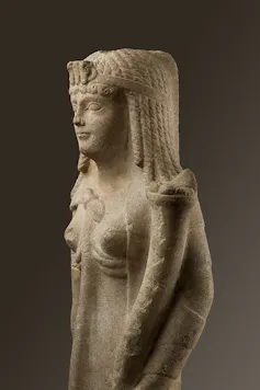 A statue of a Ptolemaic queen, perhaps Cleopatra VII, shows the young royal in her finery and holding a cornucopia.