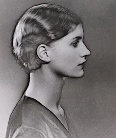 A black and white image of a young woman in profile from the 1920s.