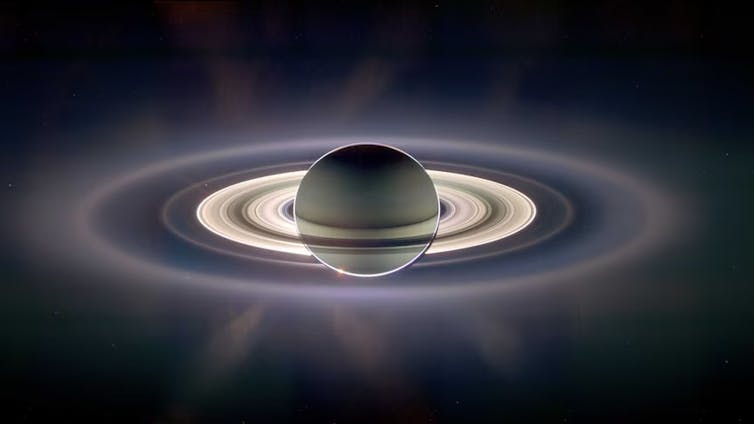 Photo of Saturn floating in space surrounded by glowing rings.