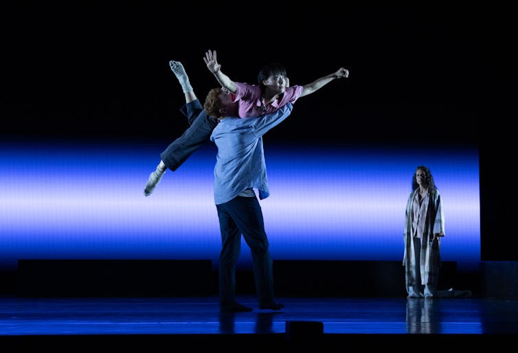 A man lifts a woman on his shoulder.