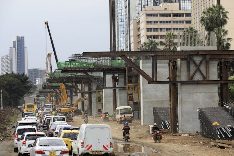 Traffic queued up beside a highway that is under construction in Kenya.